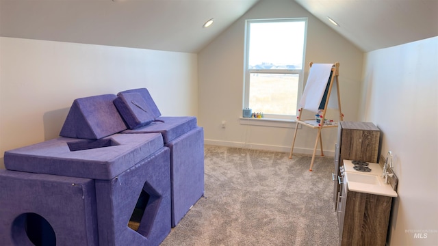 living area with lofted ceiling and light colored carpet