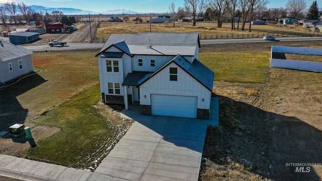 view of front of house featuring a garage, a mountain view, and a front yard