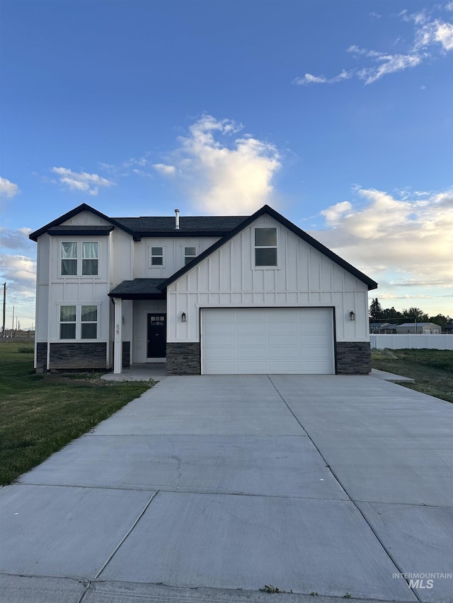629 Manning Cir, Paul, ID 83347 - modern inspired farmhouse featuring board and batten siding, stone siding, concrete driveway, and a front lawn