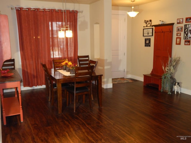 dining space with dark hardwood / wood-style floors