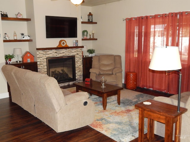 living room featuring ceiling fan and dark hardwood / wood-style flooring