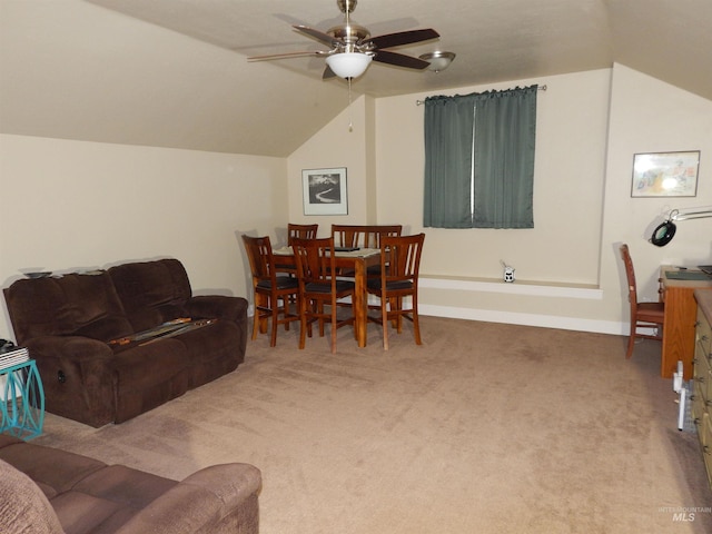 carpeted dining room featuring lofted ceiling and ceiling fan