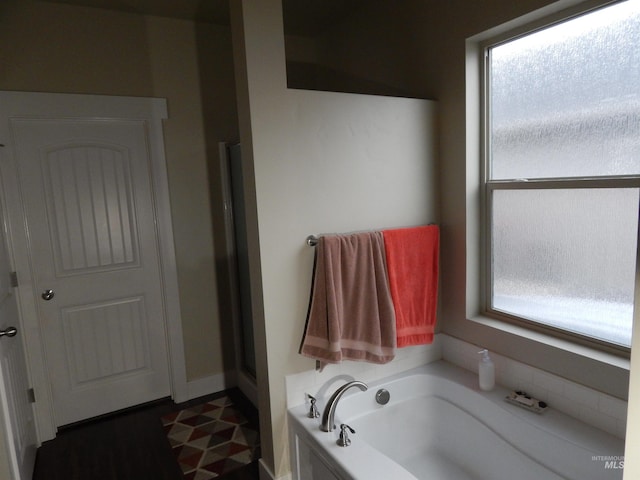 bathroom featuring a tub to relax in