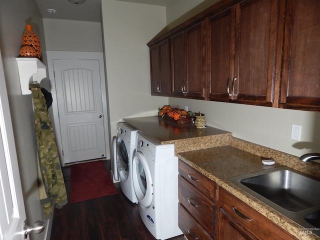 washroom with cabinets, sink, dark wood-type flooring, and washer and clothes dryer