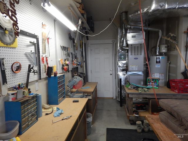 basement with gas water heater and a workshop area