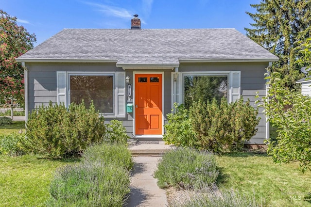 4224 W Clinton St, Boise, ID 83706 - view of front of home with a shingled roof, a chimney, and a front yard
