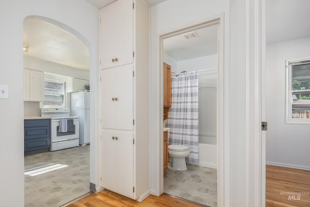4224 W Clinton St, Boise, ID 83706 - bathroom featuring toilet, wood finished floors, and shower / tub combo