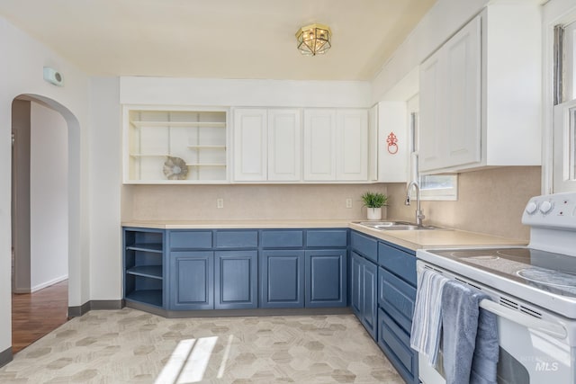 4224 W Clinton St, Boise, ID 83706 - kitchen with white electric stove, open shelves, blue cabinetry, a sink, and arched walkways