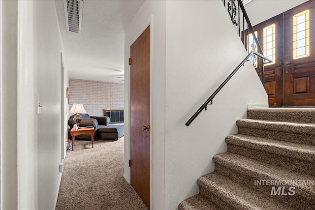 staircase with carpet flooring and french doors