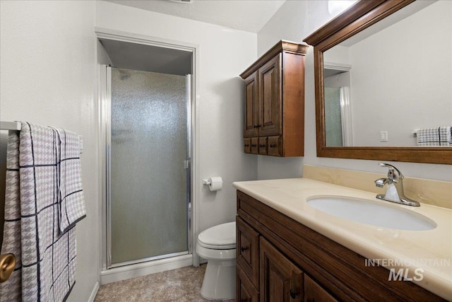 bathroom with an enclosed shower, vanity, tile patterned flooring, and toilet