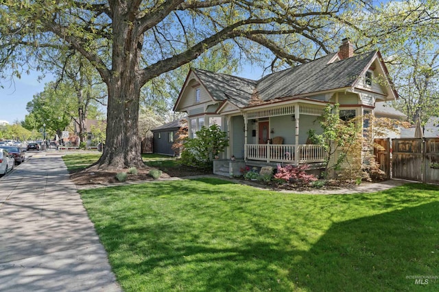 1416 N 13th St, Boise, ID 83702 - view of property exterior featuring fence, covered porch, a chimney, and a lawn