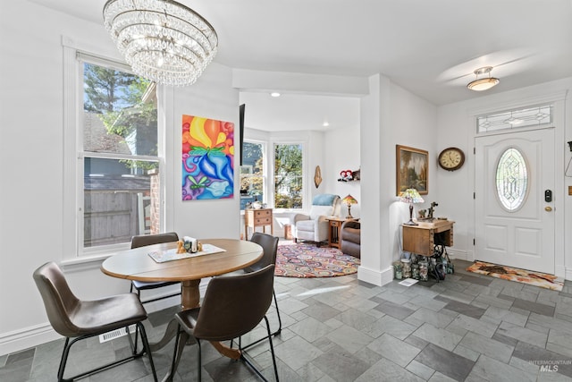 1416 N 13th St, Boise, ID 83702 - dining area featuring stone finish flooring, baseboards, and a chandelier