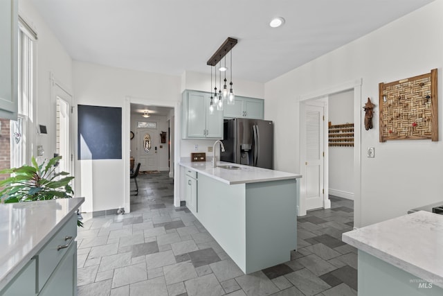 1416 N 13th St, Boise, ID 83702 - kitchen featuring pendant lighting, a peninsula, stainless steel refrigerator with ice dispenser, light countertops, and a sink