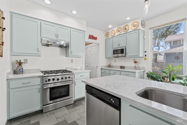 1416 N 13th St, Boise, ID 83702 - kitchen with under cabinet range hood, stainless steel appliances, light stone counters, and recessed lighting
