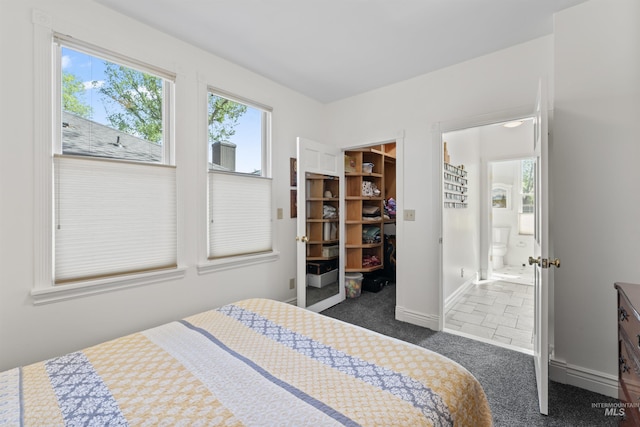 1416 N 13th St, Boise, ID 83702 - bedroom with a walk in closet, baseboards, a closet, dark colored carpet, and ensuite bathroom