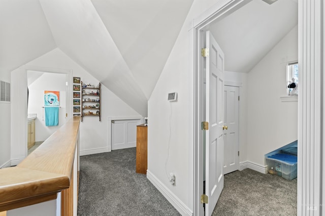 1416 N 13th St, Boise, ID 83702 - hallway featuring baseboards, vaulted ceiling, and dark colored carpet