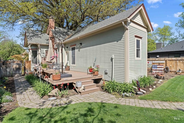 1416 N 13th St, Boise, ID 83702 - rear view of property featuring fence, a shingled roof, a wooden deck, a chimney, and a lawn