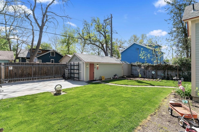 1416 N 13th St, Boise, ID 83702 - view of yard featuring an outdoor structure, a garage, a patio, a fenced backyard, and driveway