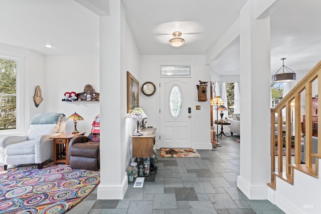 1416 N 13th St, Boise, ID 83702 - entrance foyer featuring baseboards, stone tile floors, and stairway