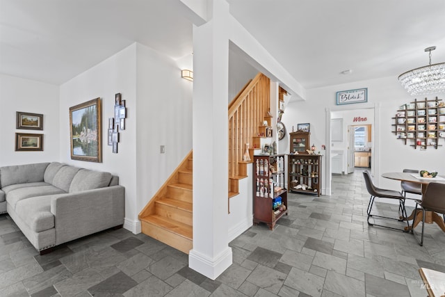 1416 N 13th St, Boise, ID 83702 - living room featuring stairway, baseboards, a chandelier, and stone tile floors