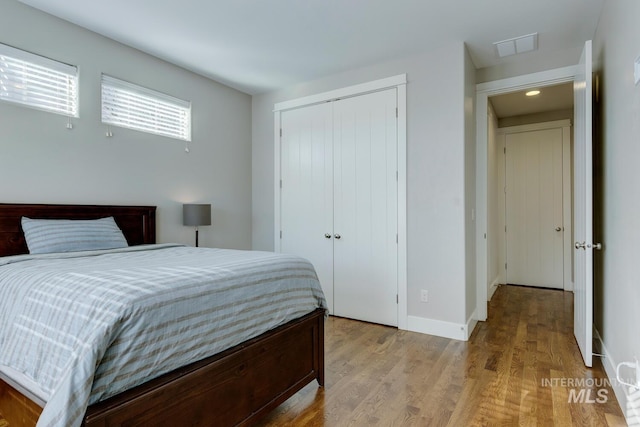 bedroom featuring a closet and light wood-type flooring