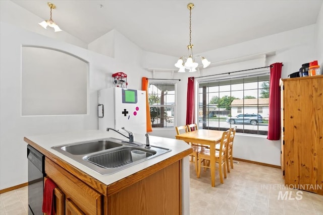 kitchen featuring white refrigerator, sink, decorative light fixtures, a kitchen island with sink, and dishwasher