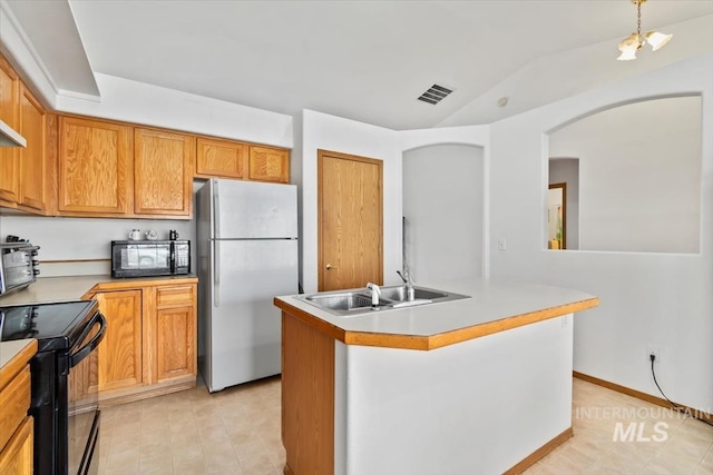 kitchen featuring an island with sink, sink, and black appliances