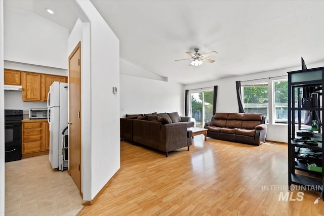 living room featuring light wood-type flooring, vaulted ceiling, and ceiling fan