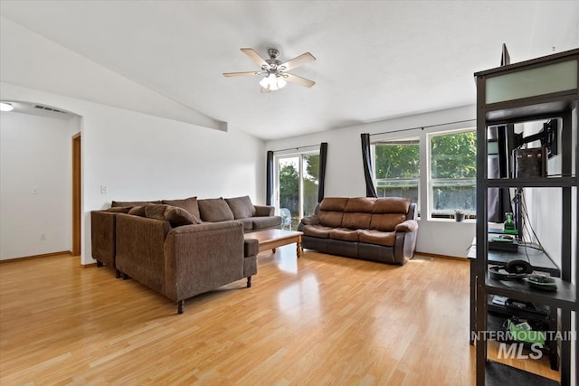 living room featuring light hardwood / wood-style flooring, vaulted ceiling, and ceiling fan