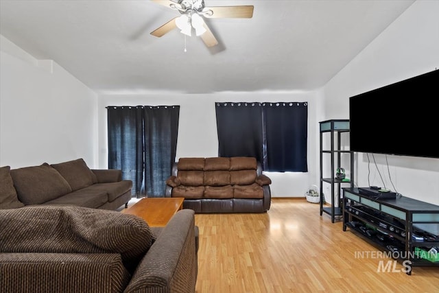 living room with ceiling fan and hardwood / wood-style floors