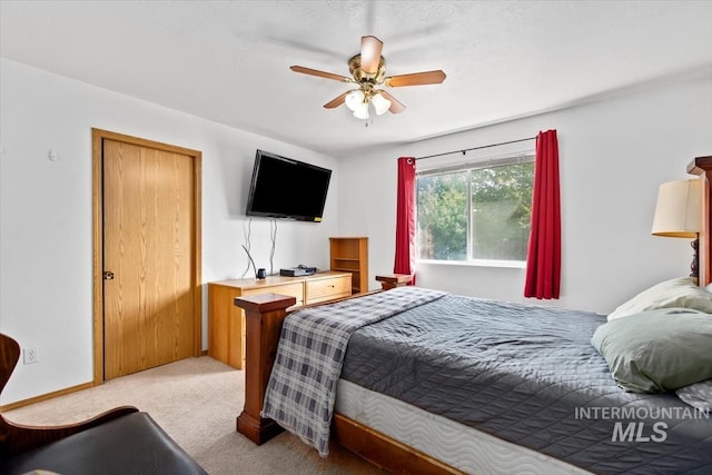 bedroom with ceiling fan and light carpet