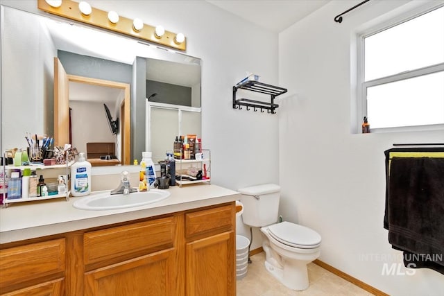 bathroom with tile patterned flooring, vanity, toilet, and a shower with shower door