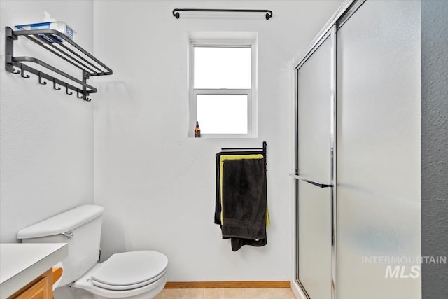 bathroom with vanity, toilet, and a shower with shower door