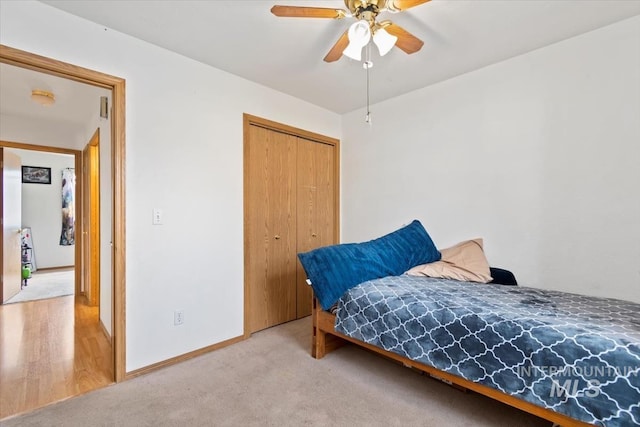 bedroom featuring ceiling fan, a closet, and light hardwood / wood-style floors