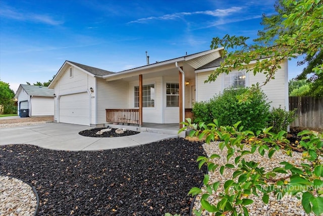 ranch-style home with covered porch and a garage