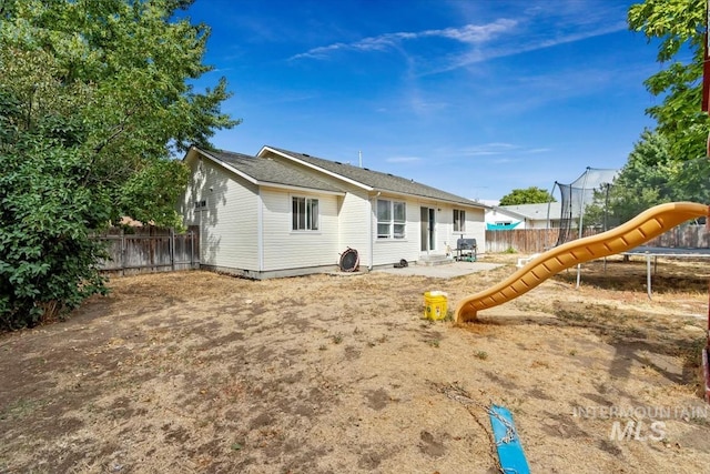 back of property featuring a playground