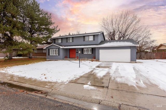 traditional-style home with an attached garage and fence