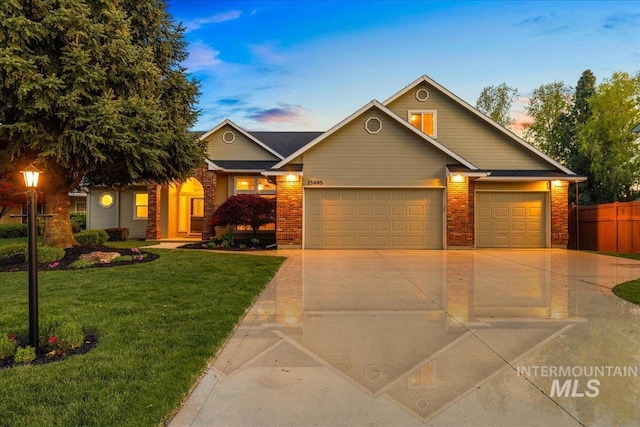 view of front of home featuring a garage, driveway, and brick siding