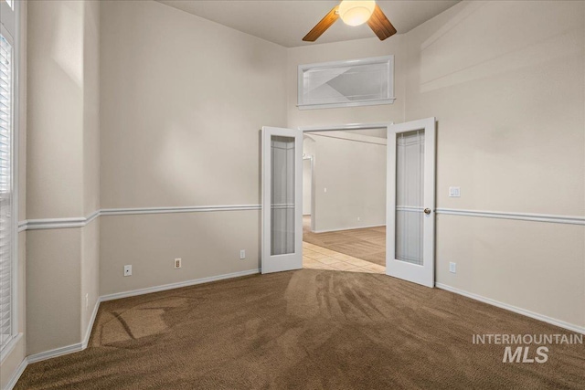 unfurnished bedroom featuring carpet, baseboards, a ceiling fan, and french doors