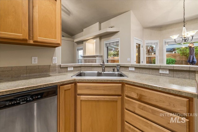 kitchen with dishwasher, a sink, a chandelier, lofted ceiling, and hanging light fixtures
