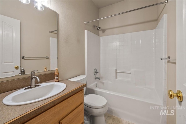bathroom with toilet, vanity, shower / bathtub combination, and a textured wall