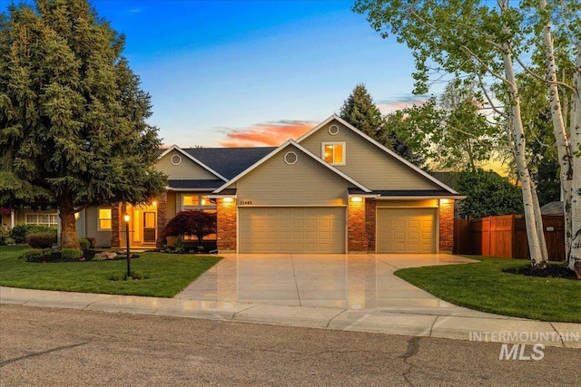 view of front of home featuring an attached garage, driveway, and brick siding