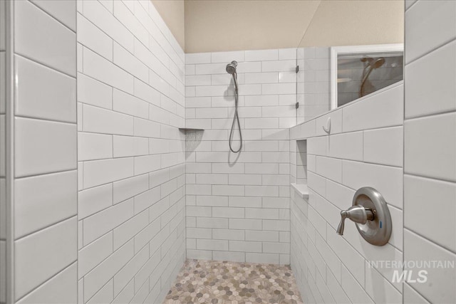 full bath featuring tiled shower