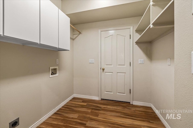 clothes washing area featuring cabinet space, dark wood finished floors, baseboards, washer hookup, and electric dryer hookup