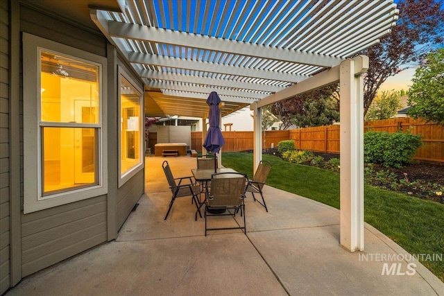 patio terrace at dusk featuring outdoor dining space and a pergola