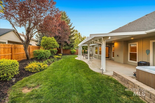 view of yard featuring a hot tub, a patio area, and a pergola