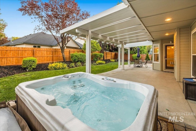 view of patio / terrace featuring a hot tub and a fenced backyard