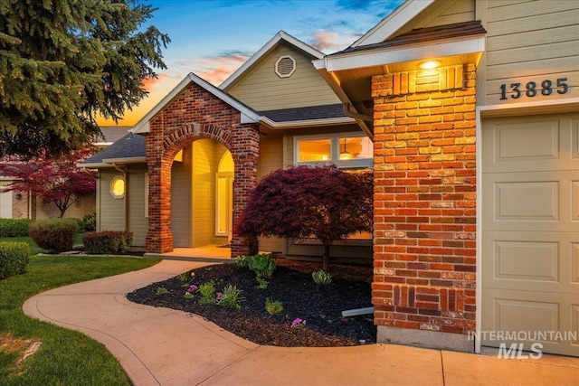 view of front of property featuring brick siding and a shingled roof