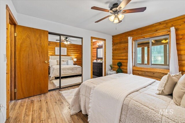 9 Elderberry Cir, Idaho City, ID 83631 - bedroom featuring rustic walls, wood-type flooring, a closet, and ceiling fan