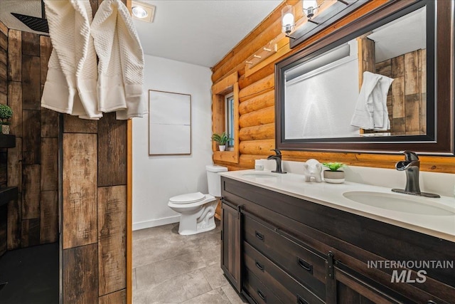 9 Elderberry Cir, Idaho City, ID 83631 - full bathroom with rustic walls, toilet, double vanity, and baseboards